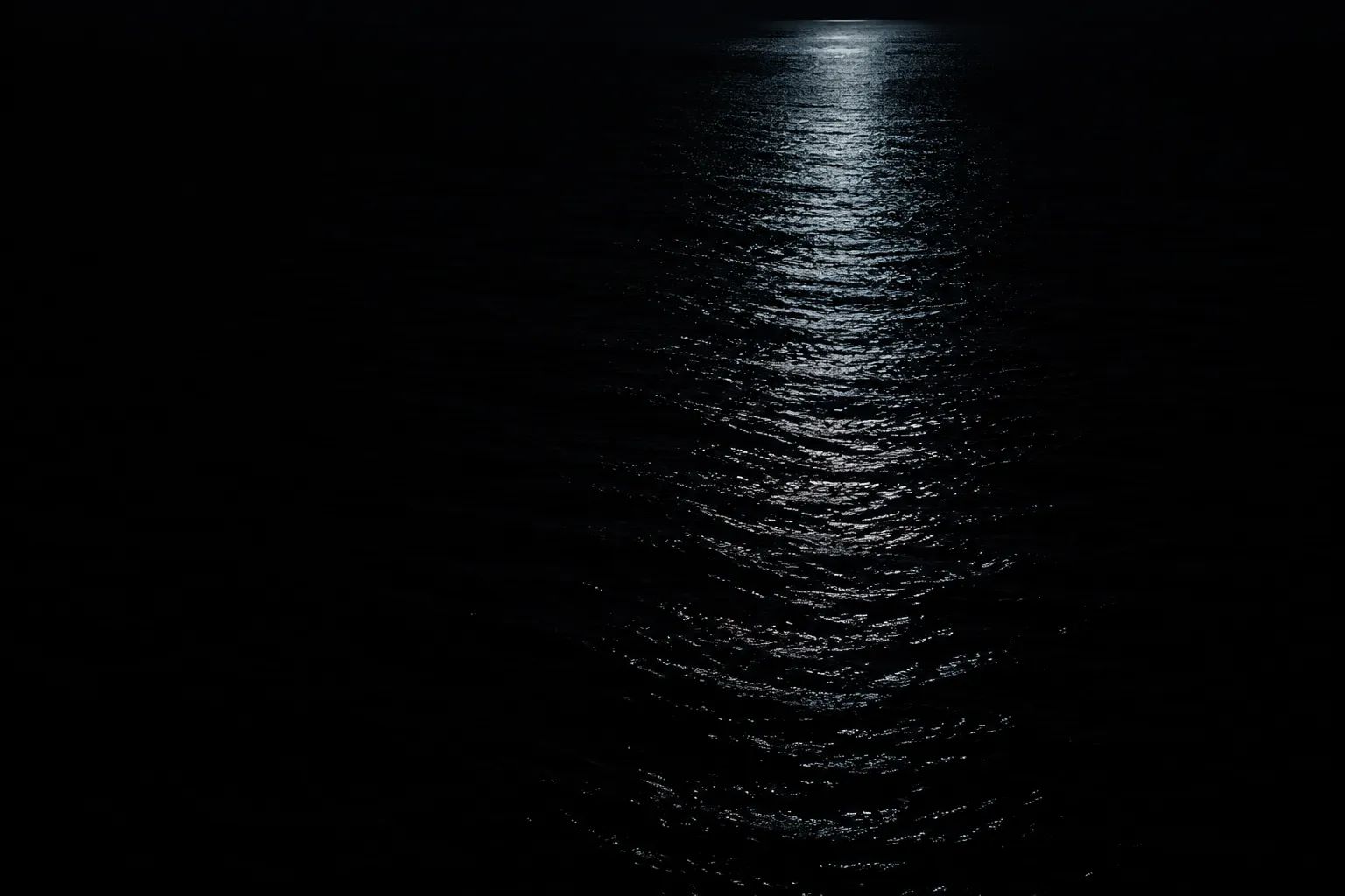 Moonlight on still dark water.